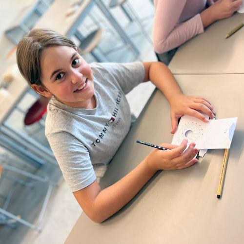 Ein Kind bastelt eine Kompassuhr